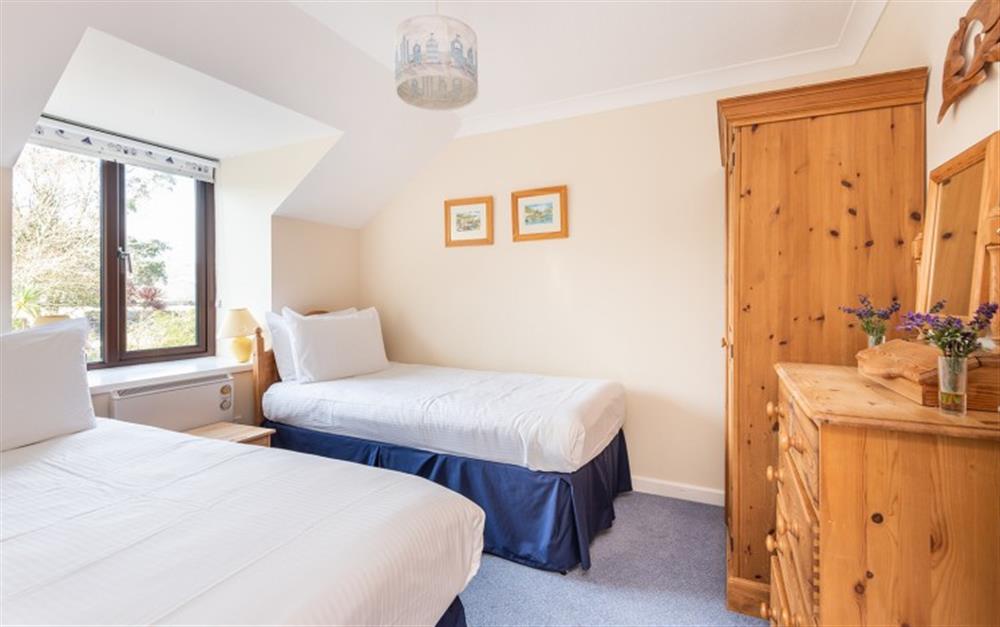 The pine furniture in the twin bedroom compliments the neutral coloured walls. at 55 Upper Maen Cottage in Maenporth
