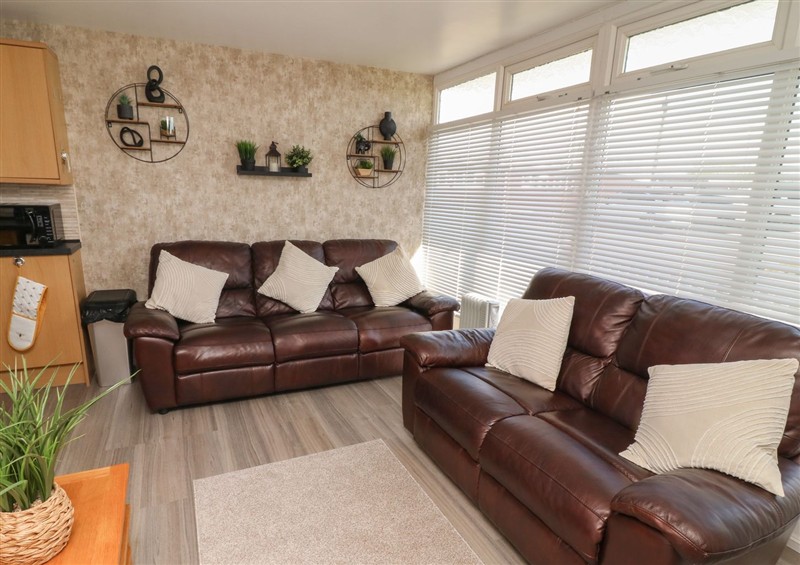 Relax in the living area at 56 Cherry Park Chalet, Chapel St Leonards