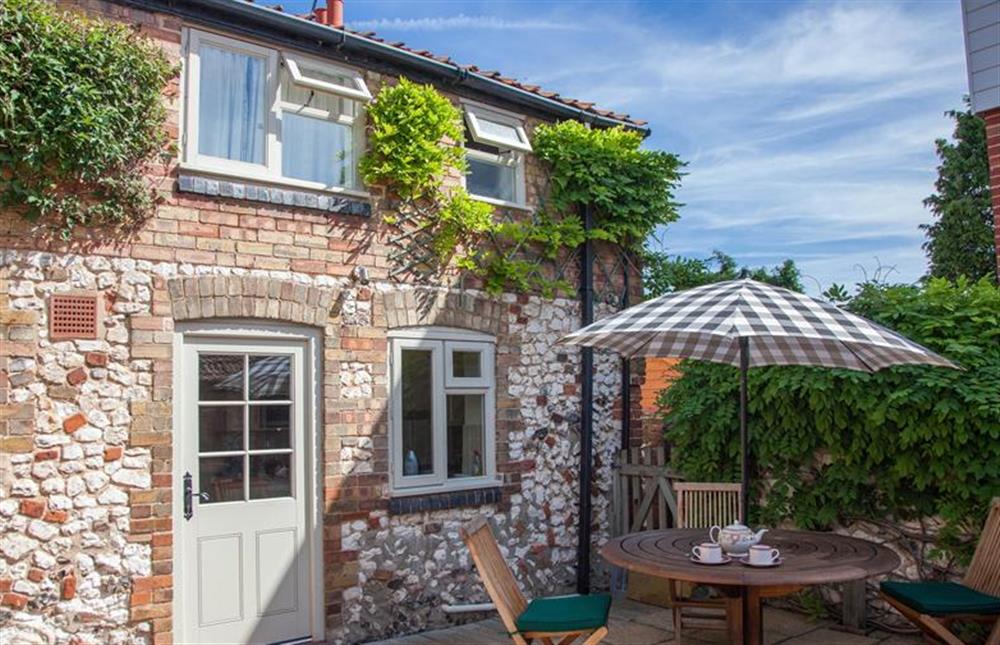 Rear Elevation:  With courtyard garden and table with seating for four at 6 Clock Row, Thornham near Hunstanton