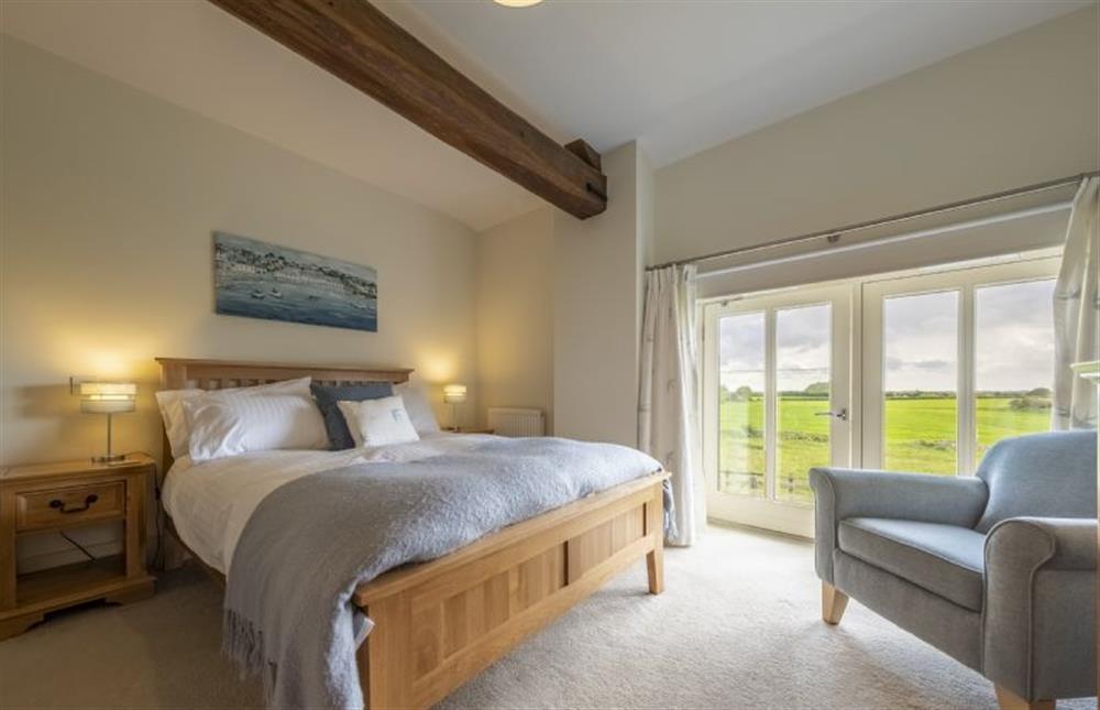 Bedroom three with double bed and Juliet balcony at 6 Courtyard Barn, Docking