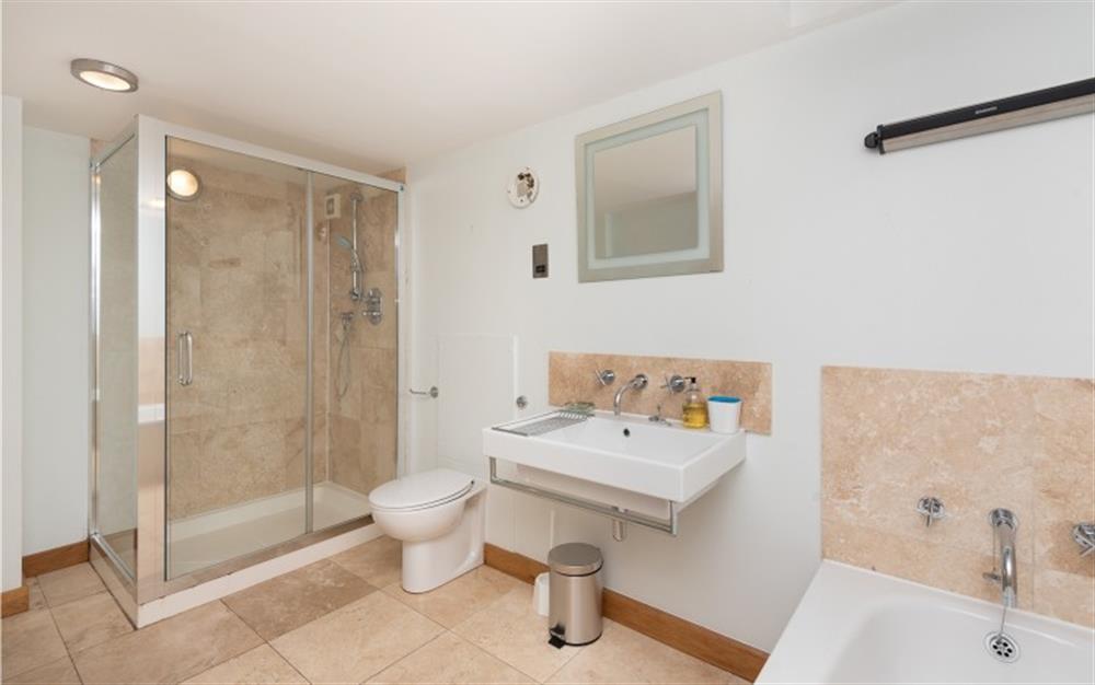 The master bedroom en suite with bath and separate shower cubicle  at 6 Harbour Yard in Salcombe