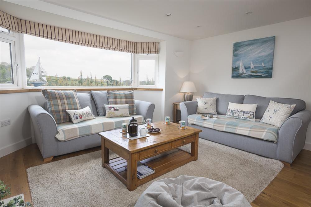 Delightful open plan sitting room with two comfortable sofas (photo 2) at 6 Knowle Court in , Salcombe