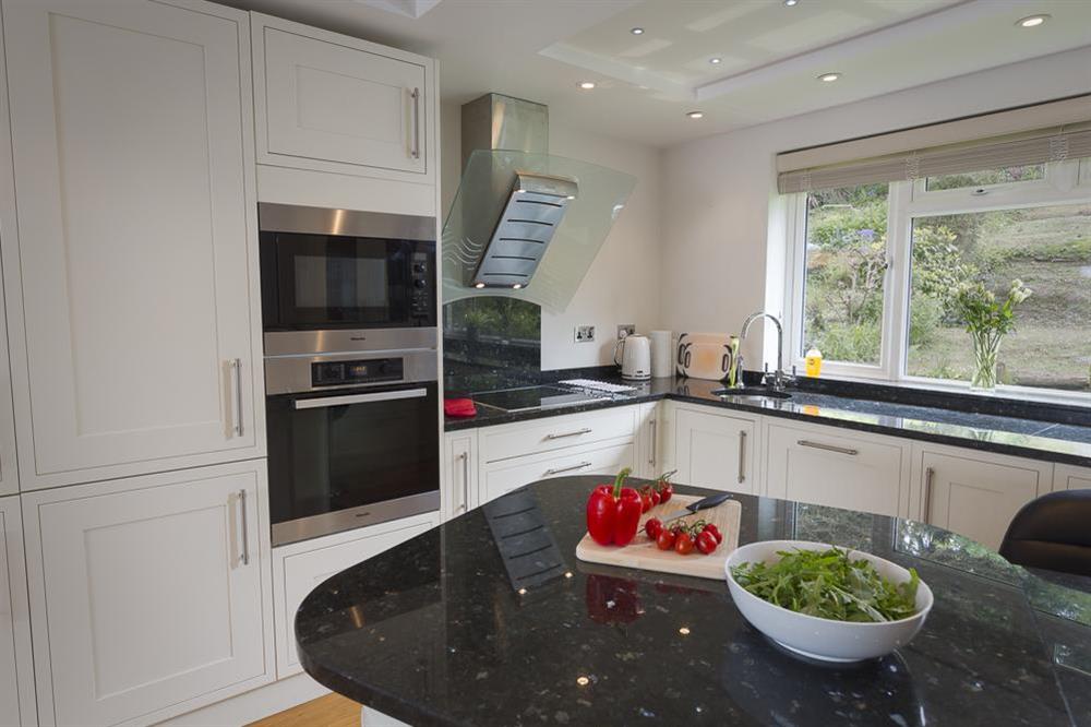 Modern kitchen with breakfast dining bar and stools (photo 2) at 6 Knowle Court in , Salcombe