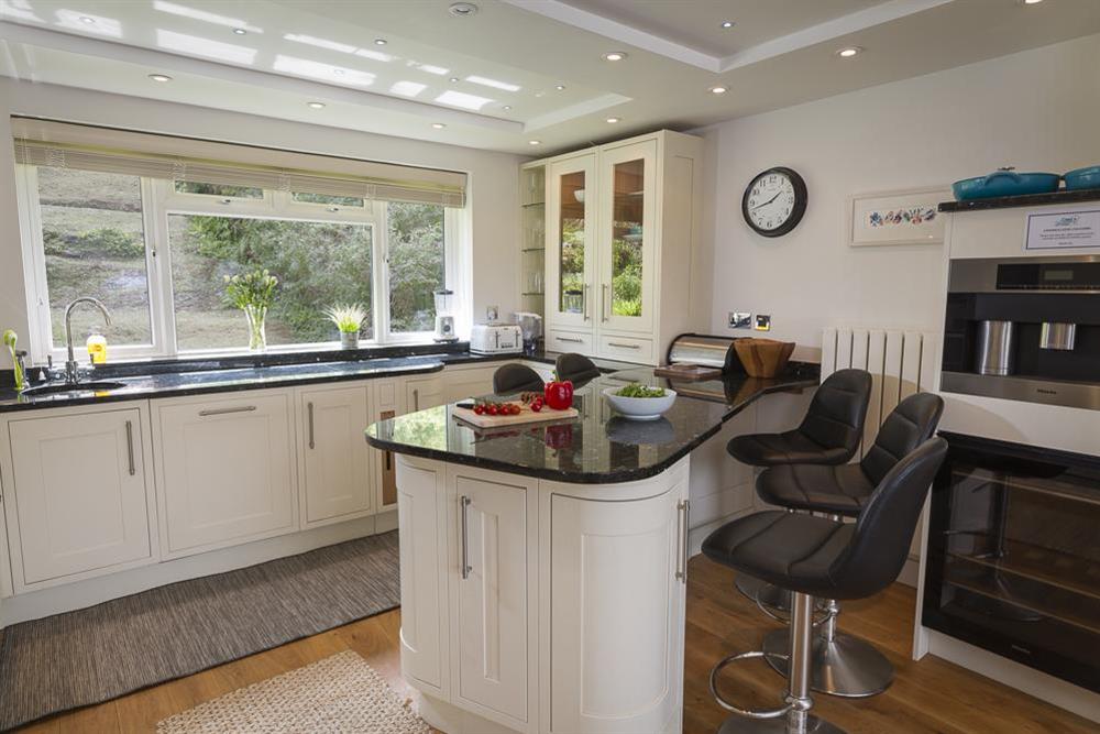 Modern kitchen with breakfast dining bar and stools at 6 Knowle Court in , Salcombe