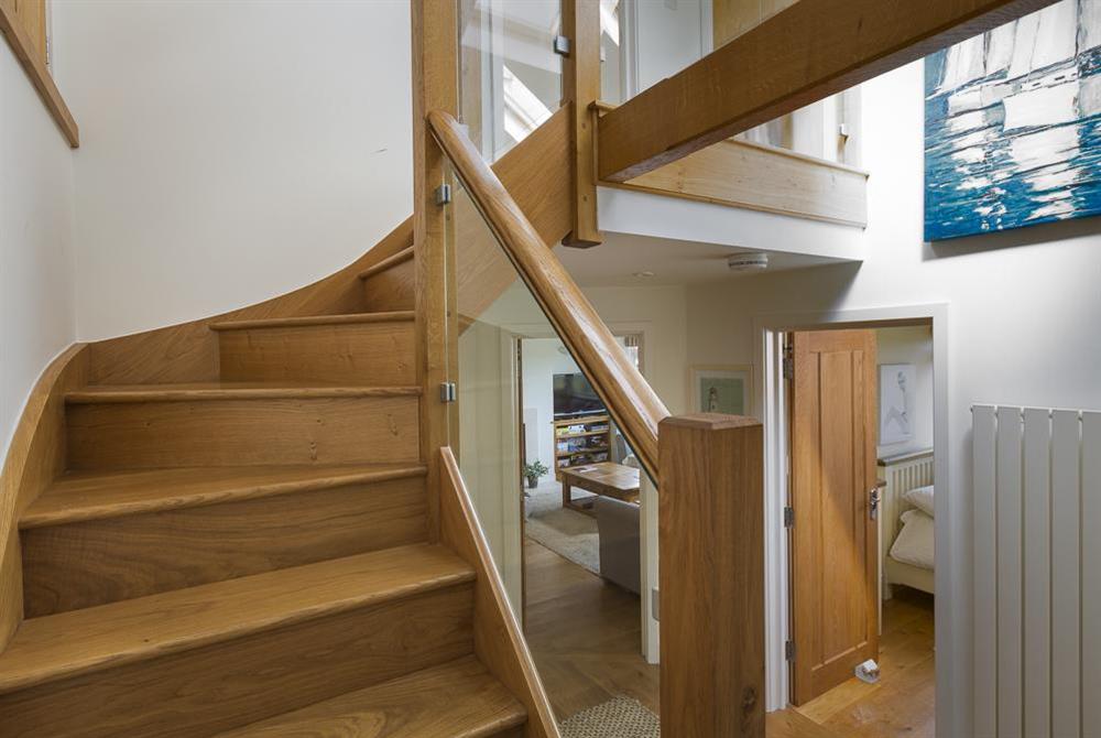 Oak and glass stairs to upper level at 6 Knowle Court in , Salcombe