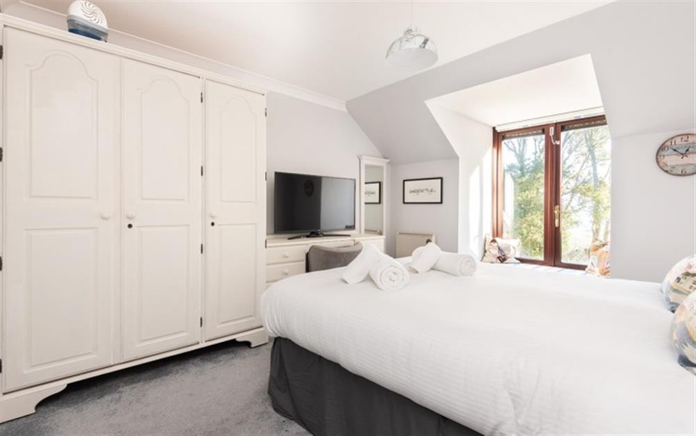 A double wardrobe and drawer space in the main bedroom, plus a TV for lazy mornings in bed! at 62 Lower Maen Cottage in Maenporth