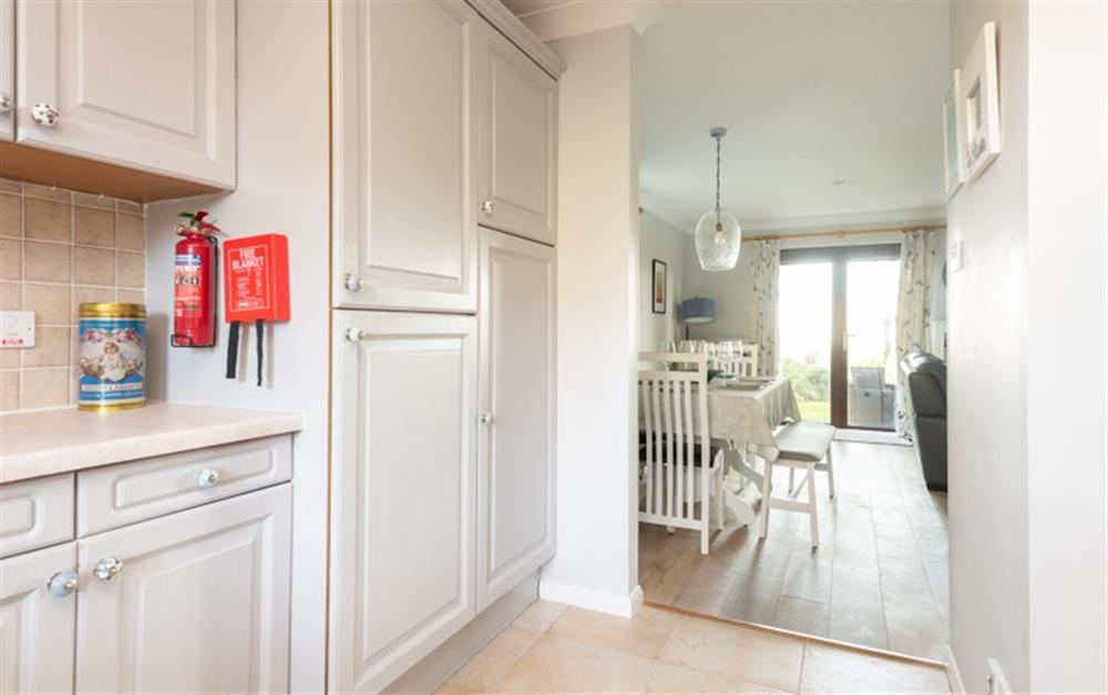 From the kitchen through the living room to the patio door. at 62 Lower Maen Cottage in Maenporth