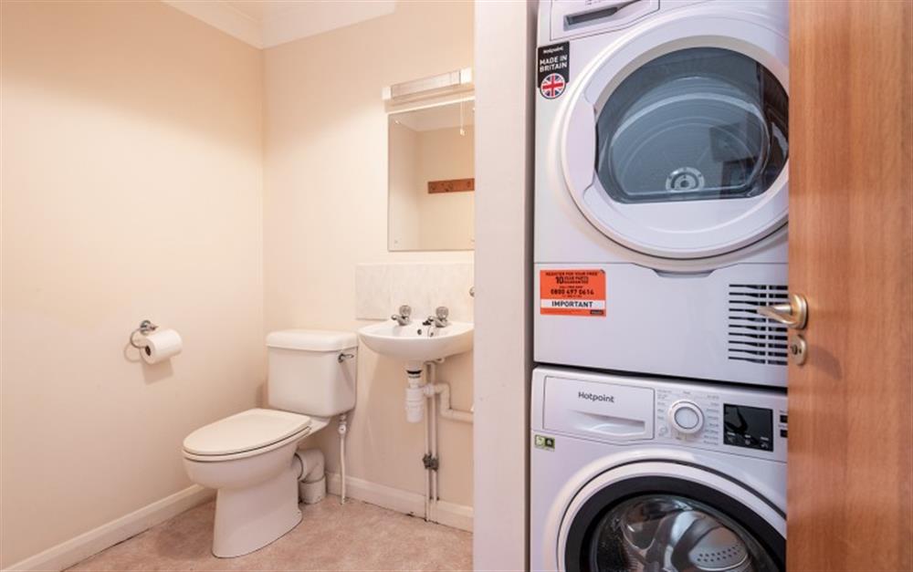 The downstairs cloakroom houses the washing machine and tumble dryer.