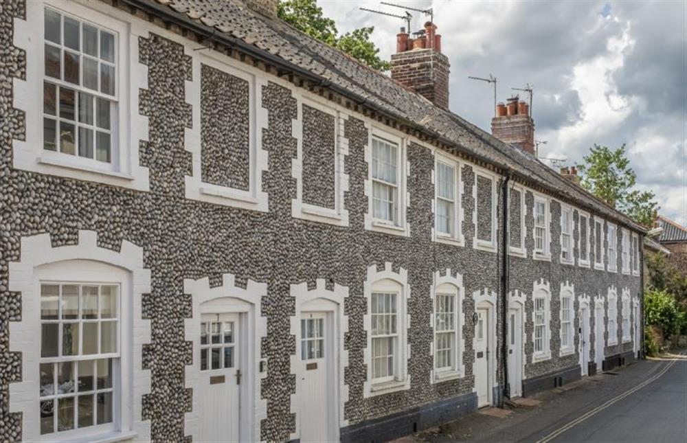 Situated within one of the most attractive terraced rows in charming Holt at 7 Albert Street, Holt