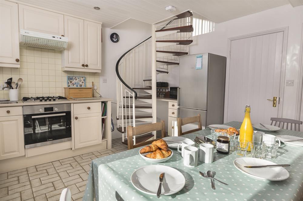Kitchen with spiral staircase leading up to lounge at 7 Island Quay in , Salcombe