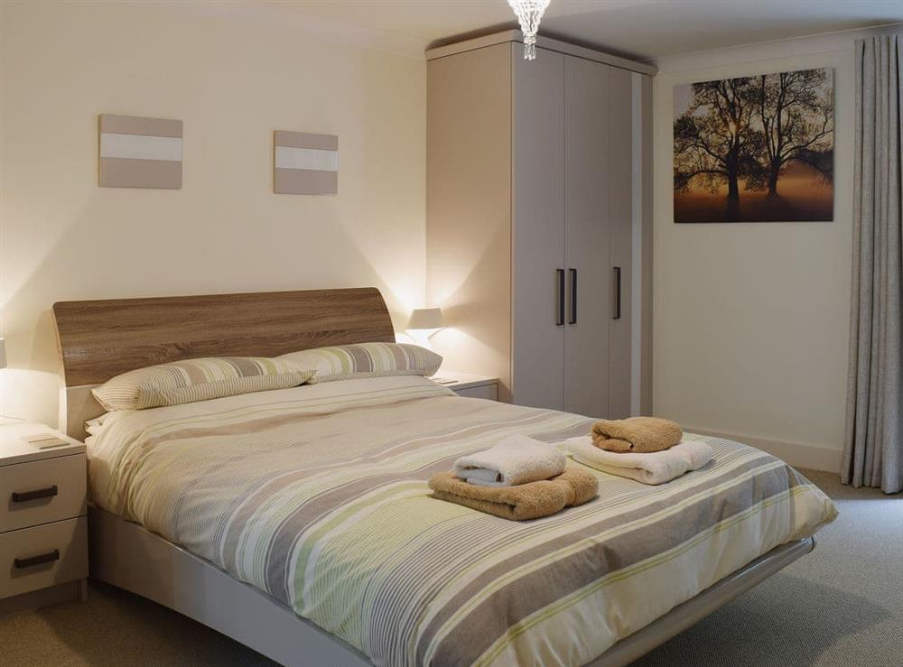 The double bedroom is warm and welcoming at 7 Ladstock Hall (deluxe) in Keswick, Cumbria