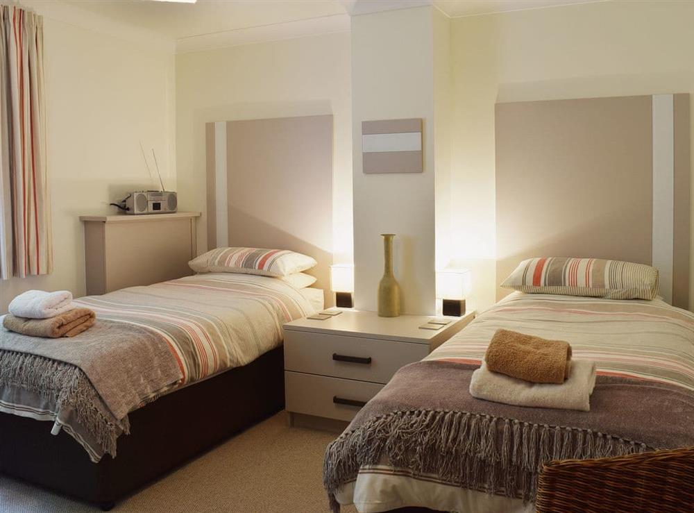 The stylish decor and contemporary furnishings of the twin room at 7 Ladstock Hall (deluxe) in Keswick, Cumbria