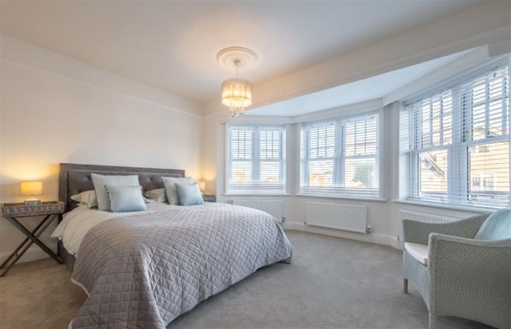 First floor: Bedroom two, at the front of the property, with a lovely bay window, super king bed and ornamental fireplace