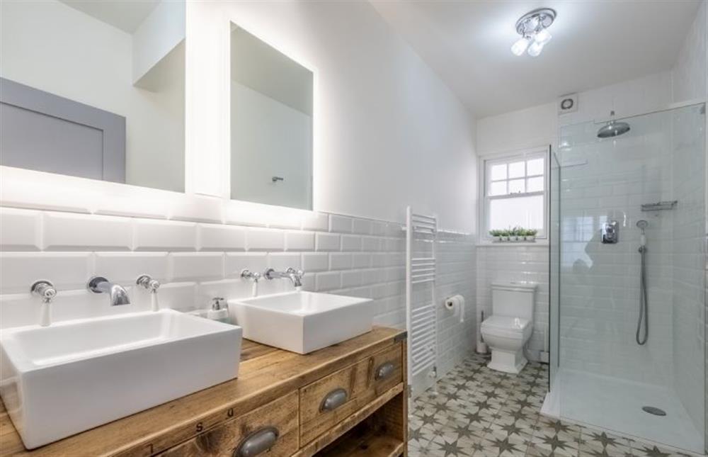 First floor: En-suite  with rain forest shower, double sink, WC and wash basin at 7 Montague Road, Sheringham