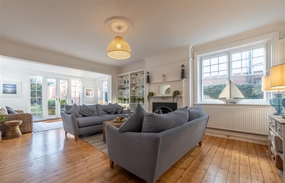 Ground floor: A bright and airy sitting room with an open fire, Smart television and french doors to the garden