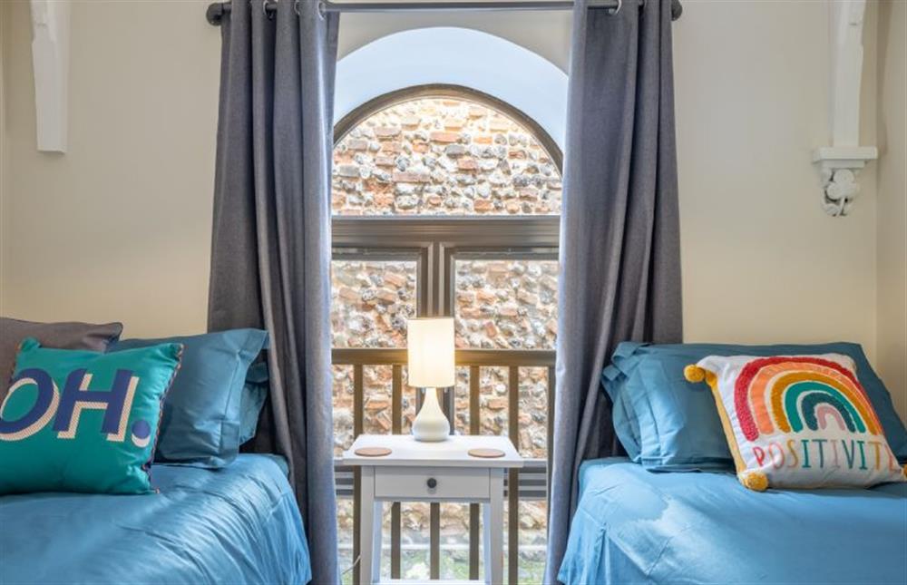 First floor: A feature window in bedroom two at 7 Swan Court, Fakenham