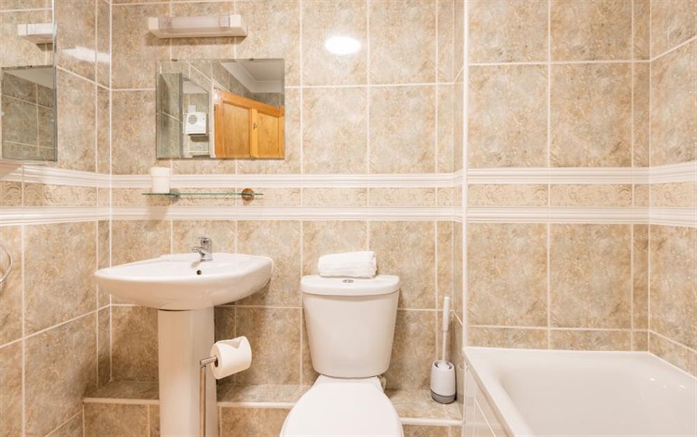 The family bathroom looks stylish with the large beige tiles. at 73 Upper Barn in Maenporth