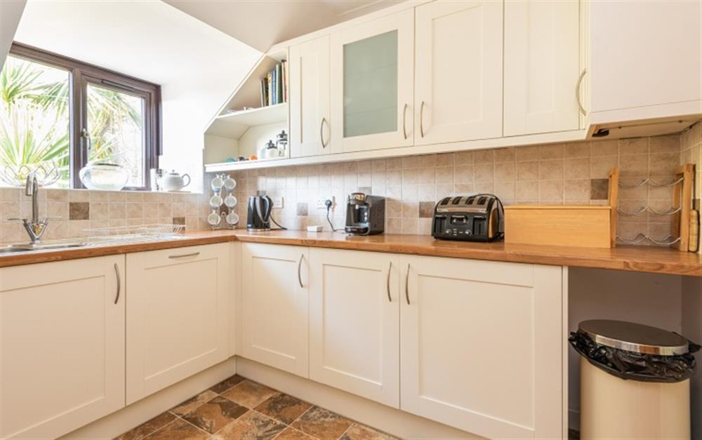 The modern fully equipped kitchen has full size integrated appliances at 73 Upper Barn in Maenporth