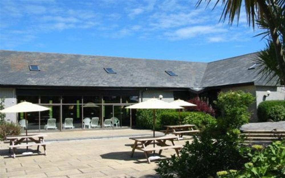 The patio outside the leisure centre has a built in barbecue and picnic tables for some al fresco eating. at 73 Upper Barn in Maenporth