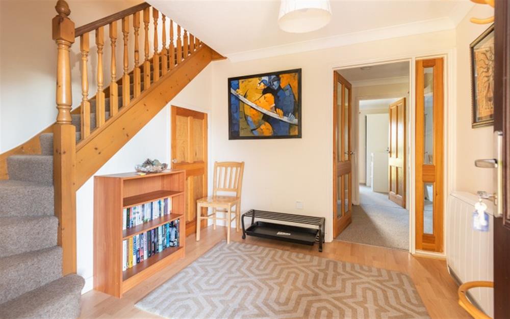 The spacious hallway with stairs leading to the living space and doors leading to the bedrooms and bathroom. at 73 Upper Barn in Maenporth