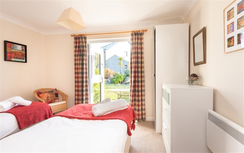 The third bedroom is a twin room with doors opening on to the patio. at 73 Upper Barn in Maenporth