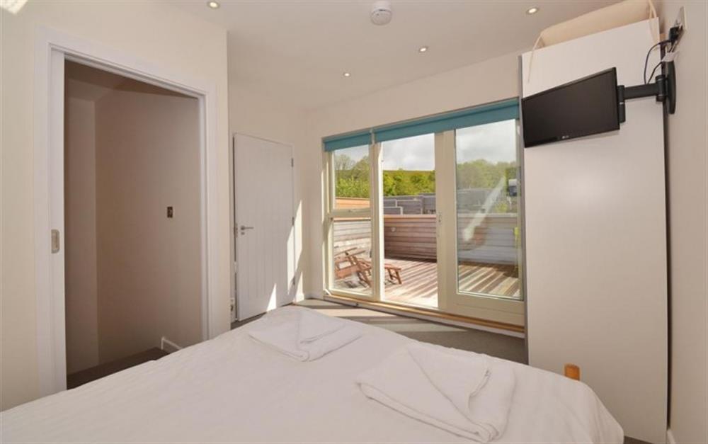 The top floor double bedroom, showing the private decking area at 8 Talland in Talland Bay