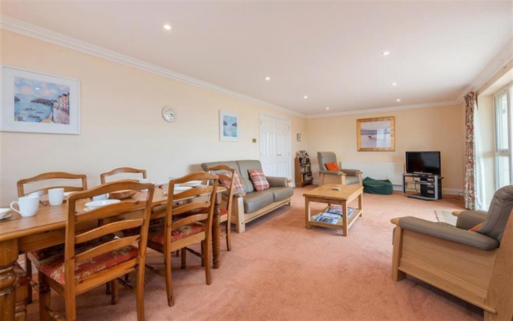 Large spacious lounge with patio doors overlooking the beach at 8 Thurlestone Rock in Thurlestone