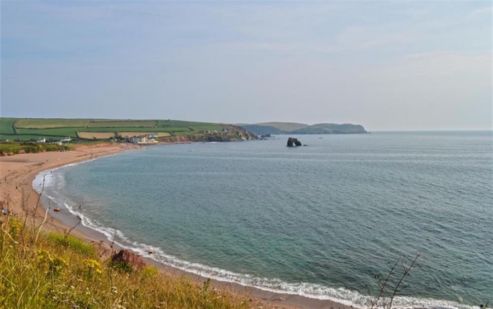 Thurlestone beach with the apartments at the far end at 8 Thurlestone Rock in Thurlestone