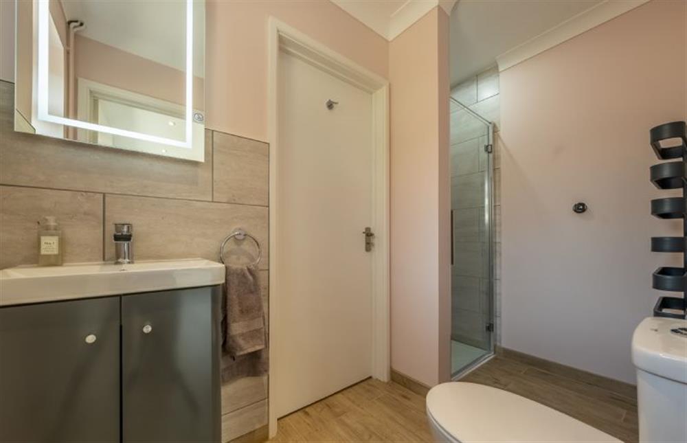 En-suite shower with heated towel rail, wash basin and WC