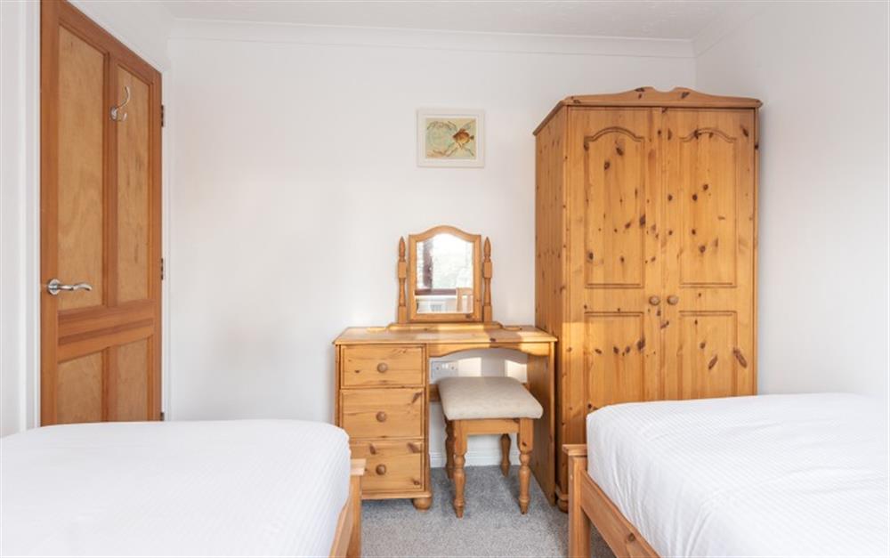 The pine furniture in the twin bedroom adds contrast to the white walls. at 88 Keepers Barn in Maenporth