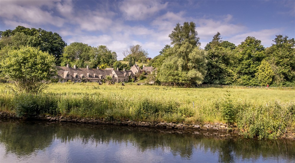 Arlington Row and the water meadow, taken from across the River Coln, Gloucestershire at 9 Arlington Row in Cirencester, Gloucestershire