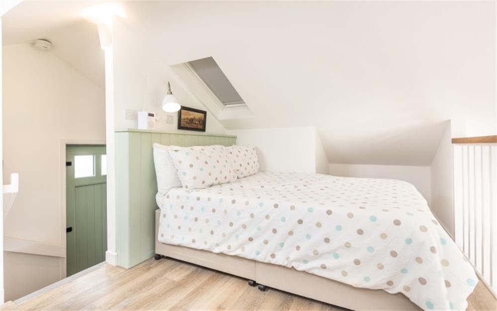 Double bed on the mezzanine level at 9 Bowling Green in Lyme Regis