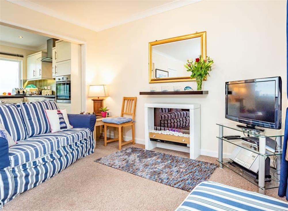 Living area and adjacent kitchen and dining areas at 9 Dolphin Court in Brixham, South Devon