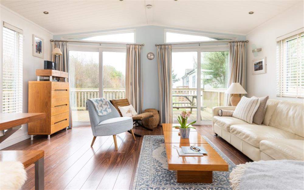 The sitting room area with ample seating. French windows leading out to the decking. at 9 Salcombe Retreat in Soar