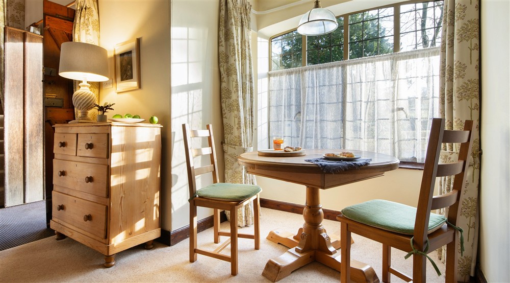 The dining area for two in the open-plan sitting and dining room at Abbey Stores in Ripon, North Yorkshire