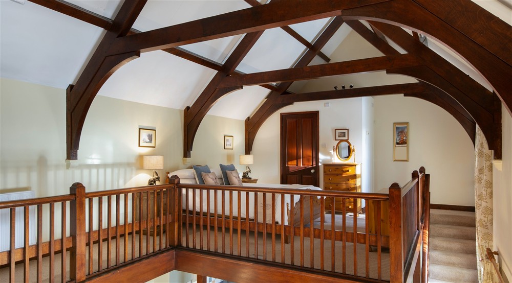 The double bedroom with beamed, vaulted ceiling at Abbey Stores in Ripon, North Yorkshire