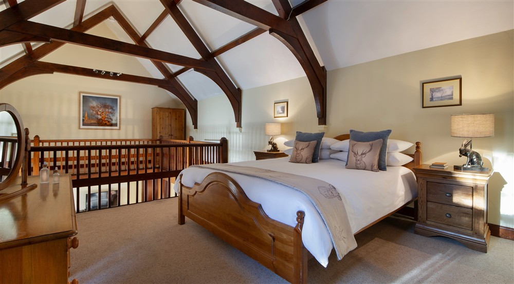 The open gallery bedroom with double bed at Abbey Stores in Ripon, North Yorkshire