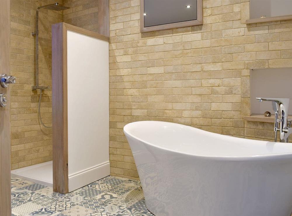 Bathroom with free-standing bath and shower area at Abbey View in Whitby, Yorkshire, North Yorkshire