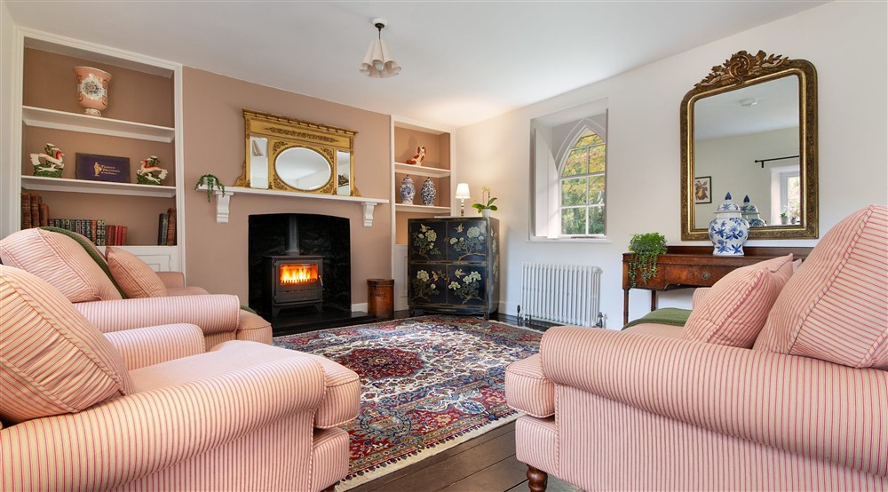 The sitting and dining room with woodburner at Abermydyr in Aberaeron, Ceredigion