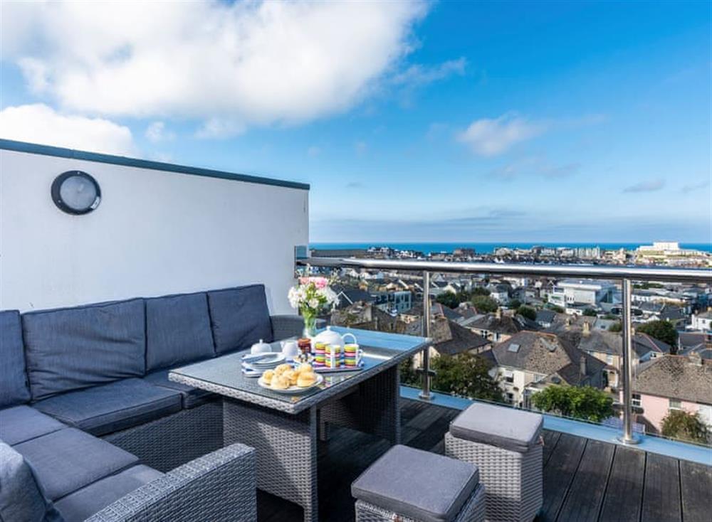 Private roof terrace with a Rattan style corner sofa and table at Above Towan @ 8 Quay Court in , Newquay