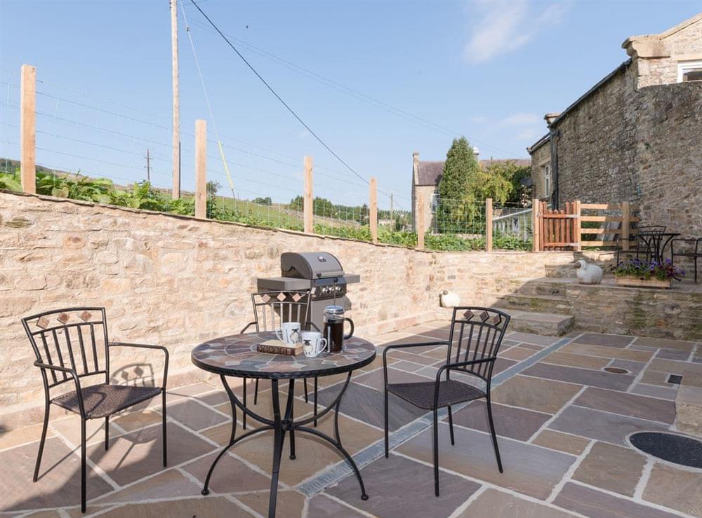 Enclosed courtyard with outdoor furniture and BBQ