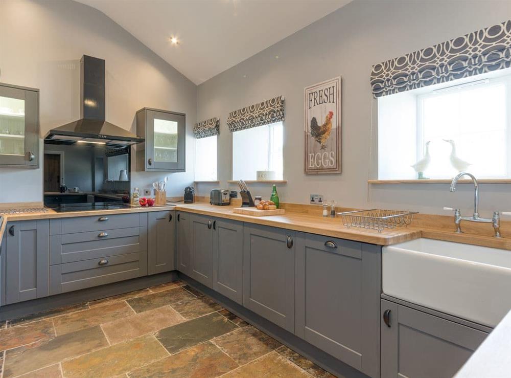 Large kitchen with slate floor at Abrahams Cottage in Langthwaite, near Leyburn, North Yorkshire