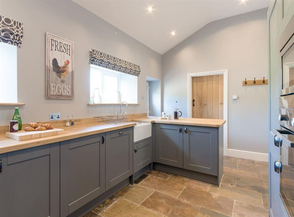 Spacious kitchen with breakfast bar at Abrahams Cottage in Langthwaite, near Leyburn, North Yorkshire