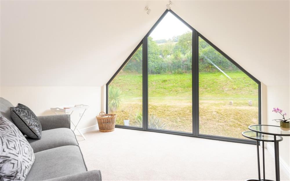 Relax in the upstairs snug with views over the garden at Acacia House in Cornworthy