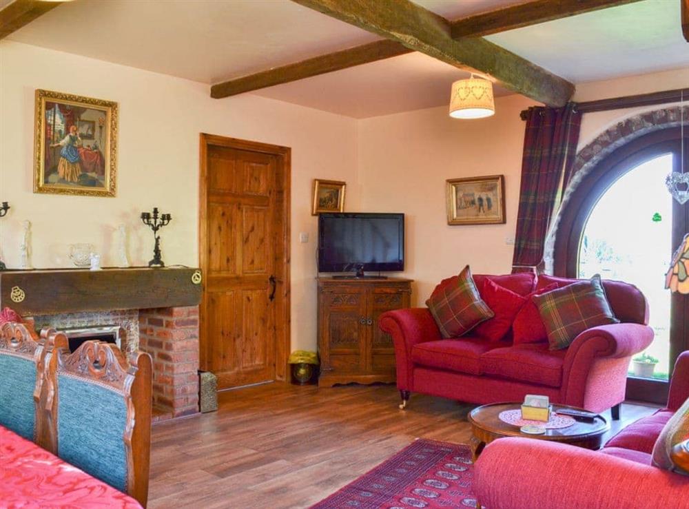 Charming beamed living area with patio doors to the garden at Acorn Barn in Laytham, near York, North Yorkshire