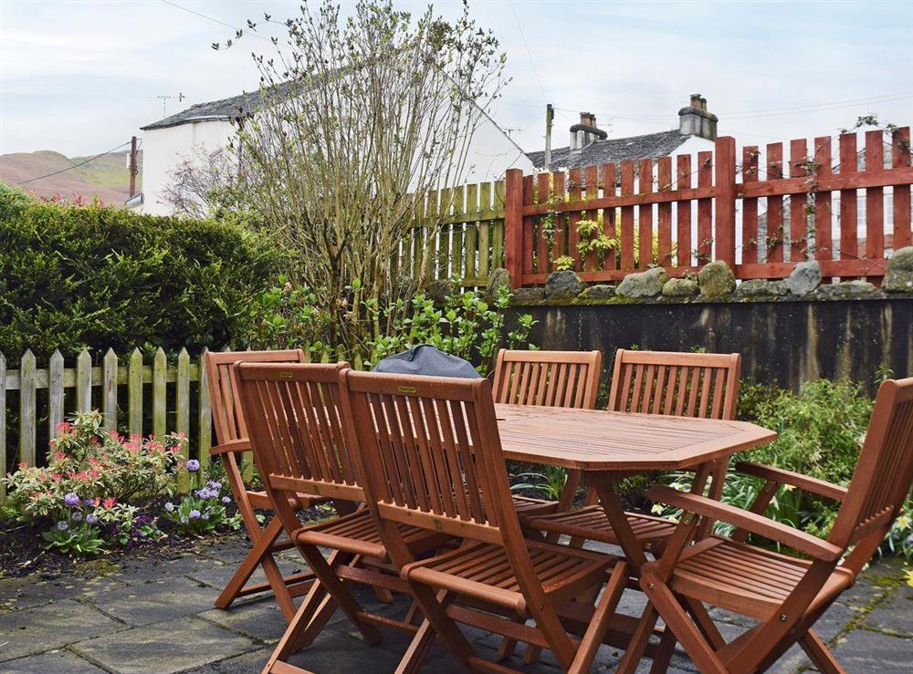 Peaceful patio with garden furniture at Acorn Cottage in Keswick, Cumbria