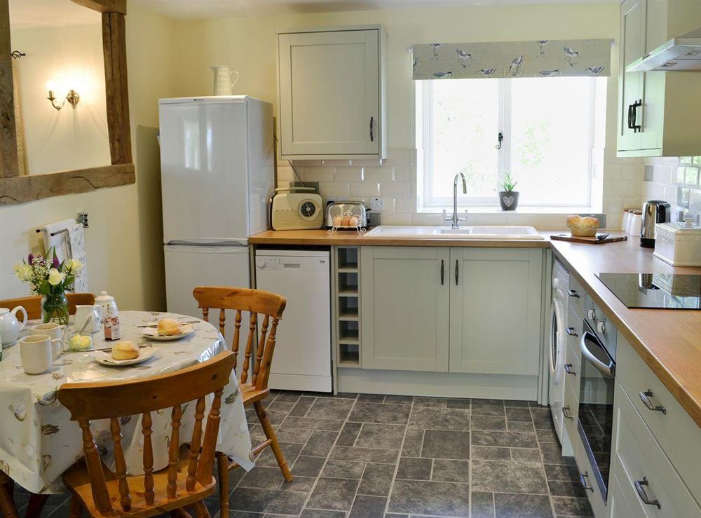 Beautifully presented kitchen/dining room with beams at Acorn Cottage in North Perrott, near Crewkerne, Somerset