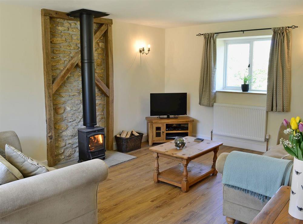 Tastefully furnished living room with cosy wood burner at Acorn Cottage in North Perrott, near Crewkerne, Somerset