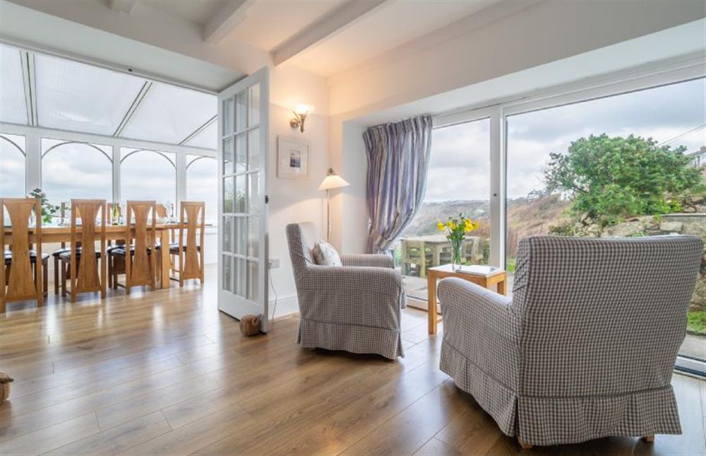 Conservatory and dining room with a table and seating for eight at Adanac, Sennen Cove