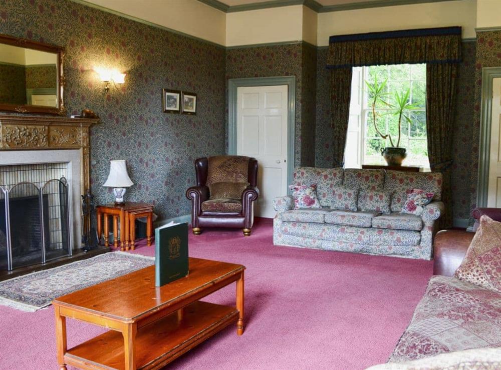 Large sitting room with open fire (photo 2) at Akeld Manor House in Akeld, Wooler, Northumberland., Great Britain